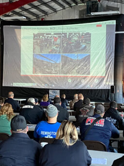 members at Tesla event watching presentation